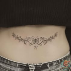 a woman's stomach with a tattoo on it