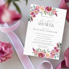 a pink ribbon and flowers are on the table next to a card that says, flower shower