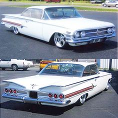 two old cars parked next to each other in a parking lot, one white and the other red