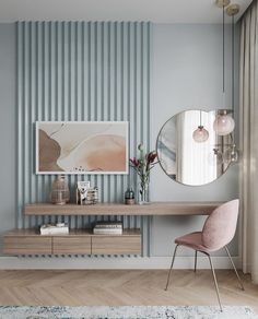 a living room with blue and white stripes on the wall, a pink chair and a round mirror