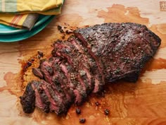 a piece of steak sitting on top of a wooden cutting board