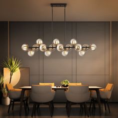 a dining room with a table, chairs and a large light fixture hanging from the ceiling