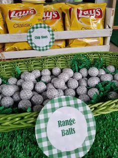 a basket filled with lots of chocolate covered balls next to bags of chips and candy