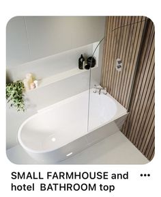 a white bath tub sitting next to a wooden shower door in a bathroom with the words small farmhouse and hotel bathroom top