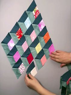 someone is making a patchwork wall hanging