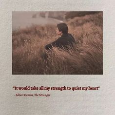 a man sitting in tall grass with a quote on the front and back of it