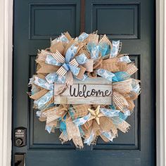 a welcome sign is attached to a door with burlocks and bows on it