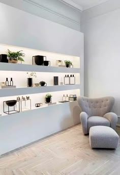 a chair sitting in front of a shelf filled with potted plants on it's sides