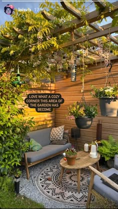 an outdoor living area with potted plants and furniture