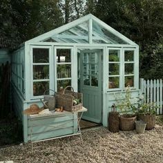 an image of a small green house in the yard