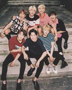 a group of young men sitting on top of steps