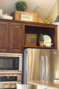 a kitchen with wooden cabinets and stainless steel appliances