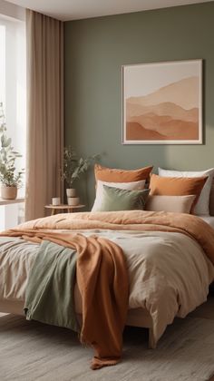 a large bed sitting in a bedroom next to a window with an orange blanket on top of it