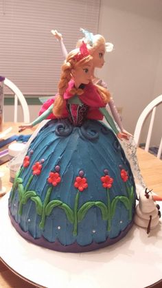 there is a cake shaped like a princess on the table