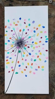 a card with confetti sprinkles on it, sitting on a stone surface