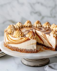 a cheesecake on a cake plate with one slice cut out and ready to be eaten