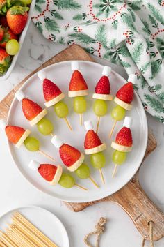 fruit skewers on a plate with strawberries and grapes