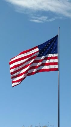 an american flag flying high in the sky