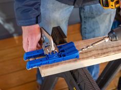 a man is working with tools on a piece of wood