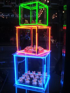 a neon display case with cupcakes in it