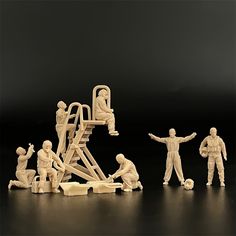 several toy figurines are arranged in the shape of men working on a ladder