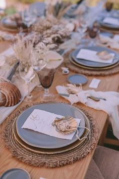 the table is set with plates and place settings