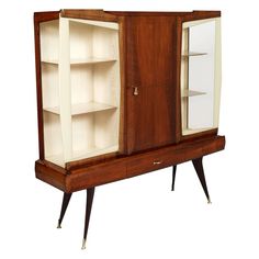 an old fashioned wooden cabinet with glass doors