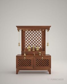 a wooden cabinet with two bells on the front and one door open to reveal an intricate lattice design