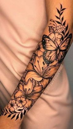 a woman's arm with flowers and butterflies on it