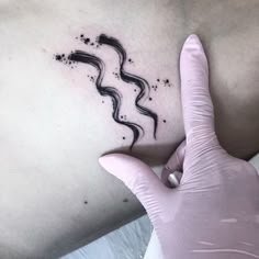 a woman's arm with black ink on it