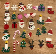 christmas decorations made out of perler beads on a wooden table