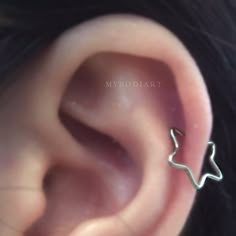 a close up of a person's ear with an ear piercing