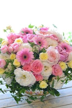 a basket filled with lots of pink and white flowers