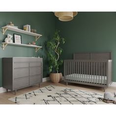 a baby's room with green walls and grey crib, white rug, wooden shelves, and gray dresser