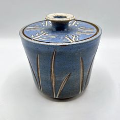 a blue and white vase sitting on top of a table