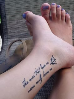 a woman's foot with a tattoo saying the one that love is never truly loved