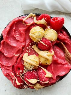 a dessert with raspberries, bananas and other toppings on top of it