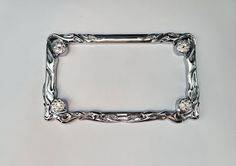 an ornate silver frame with diamonds on it