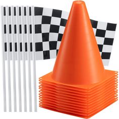 an orange traffic cone next to several white and black checkered paper dividers on a white background