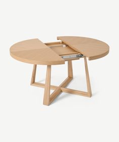 a wooden table with an open laptop on it's top and one section missing