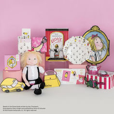 a stuffed doll sitting next to many gift boxes