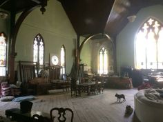 a large room with stained glass windows and furniture