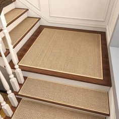 a set of stairs with carpet on the bottom and handrails to the top