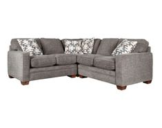 a gray sectional couch with pillows on it's back and the arms folded out