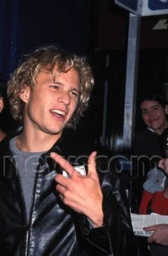 a man in a leather jacket talking to someone