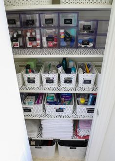 the closet is organized with plastic bins