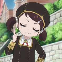 an anime character is holding her finger up in front of the camera while wearing a black and gold outfit