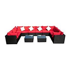 a red and black couch sitting on top of a white floor next to two tables