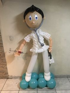 an inflatable statue of a doctor on top of blue balls