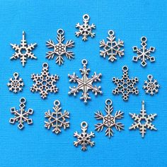 twelve silver snowflake charms on a blue background